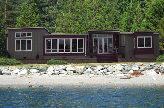 Timberland Homes in Auburn WA modern gray and burgundy colored home on the beach.